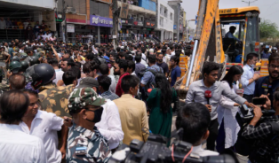 Residents of Shaheen Bagh surround officials during a demolition drive in New Delhi on May 9. (Manish Swarup/AP)